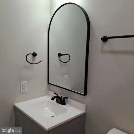 a bathroom with a sink mirror and vanity