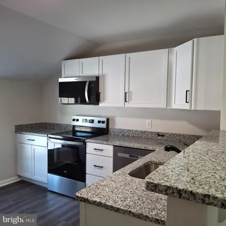 a kitchen with a stove and a sink