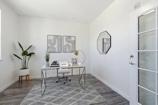 a living room with a table and a potted plant