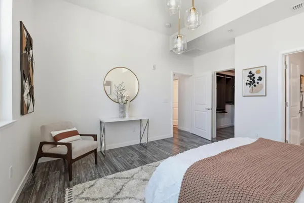 a bedroom with bed and a chandelier