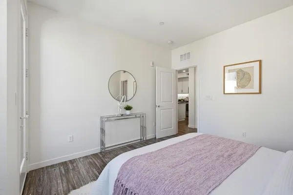 a bedroom with a bed and a mirror