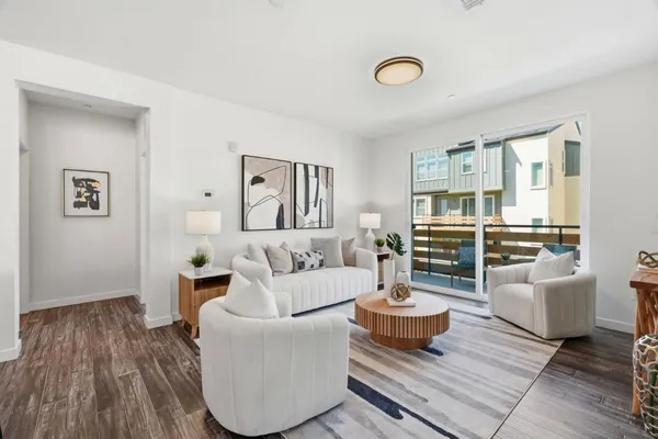 a living room with furniture and wooden floor