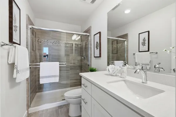 a bathroom with a sink toilet and shower