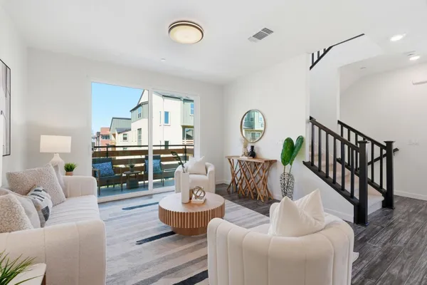 a living room with furniture and wooden floor