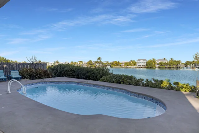 a view of a lake with houses in the back