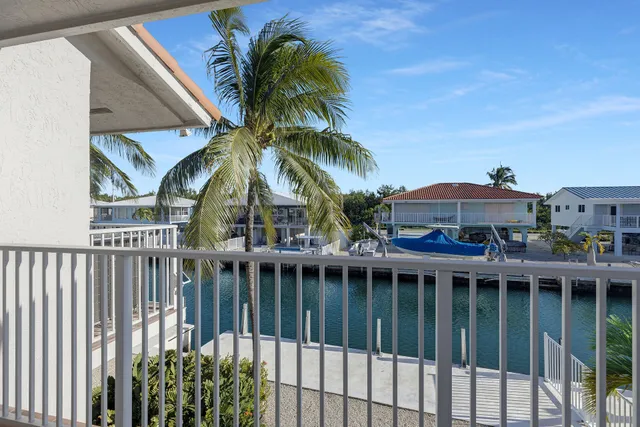 a bathroom with a granite countertop sink toilet a mirror and shower