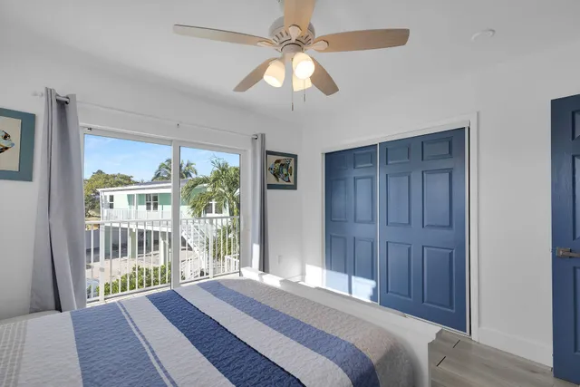 a spacious bedroom with a bed and a window