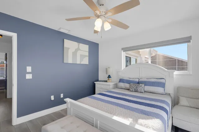 a bedroom with a large bed and a chandelier