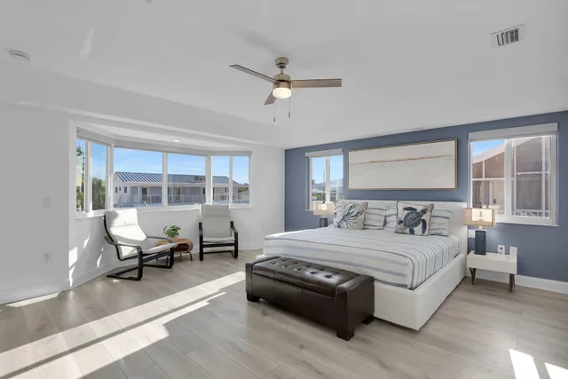 a bedroom with a bed and a large window