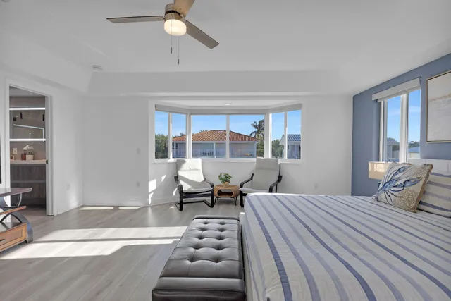 a bedroom with furniture and a wooden floor