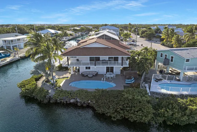 an aerial view of a house with garden space and lake view