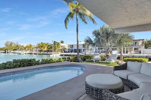 a view of a patio with couches and pool