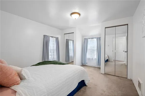 a spacious bedroom with a bed and a table