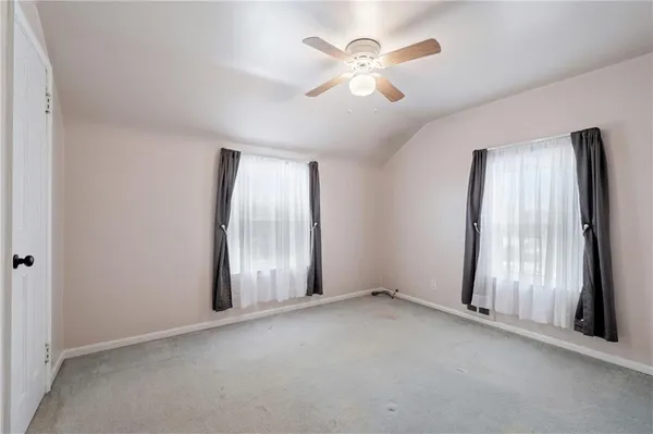 an empty room with windows and closet