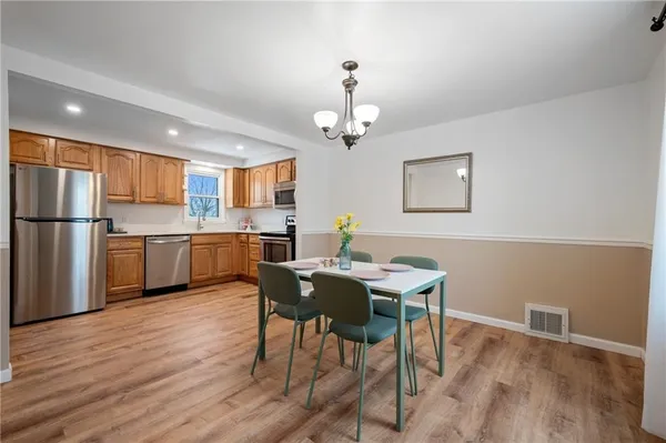 a view of a dining room with furniture wooden floor and chandelier