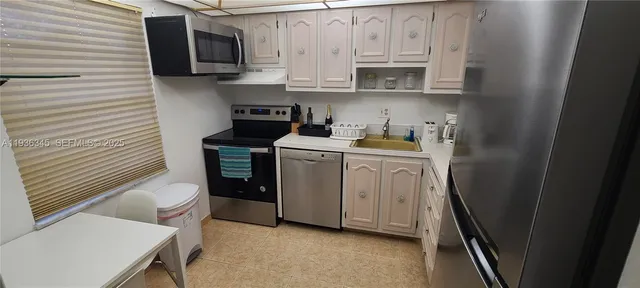 a kitchen with stainless steel appliances granite countertop a washer and dryer