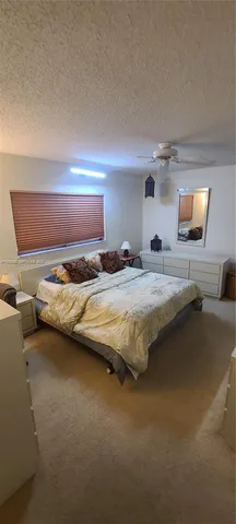 a bedroom with a bed and a night stand