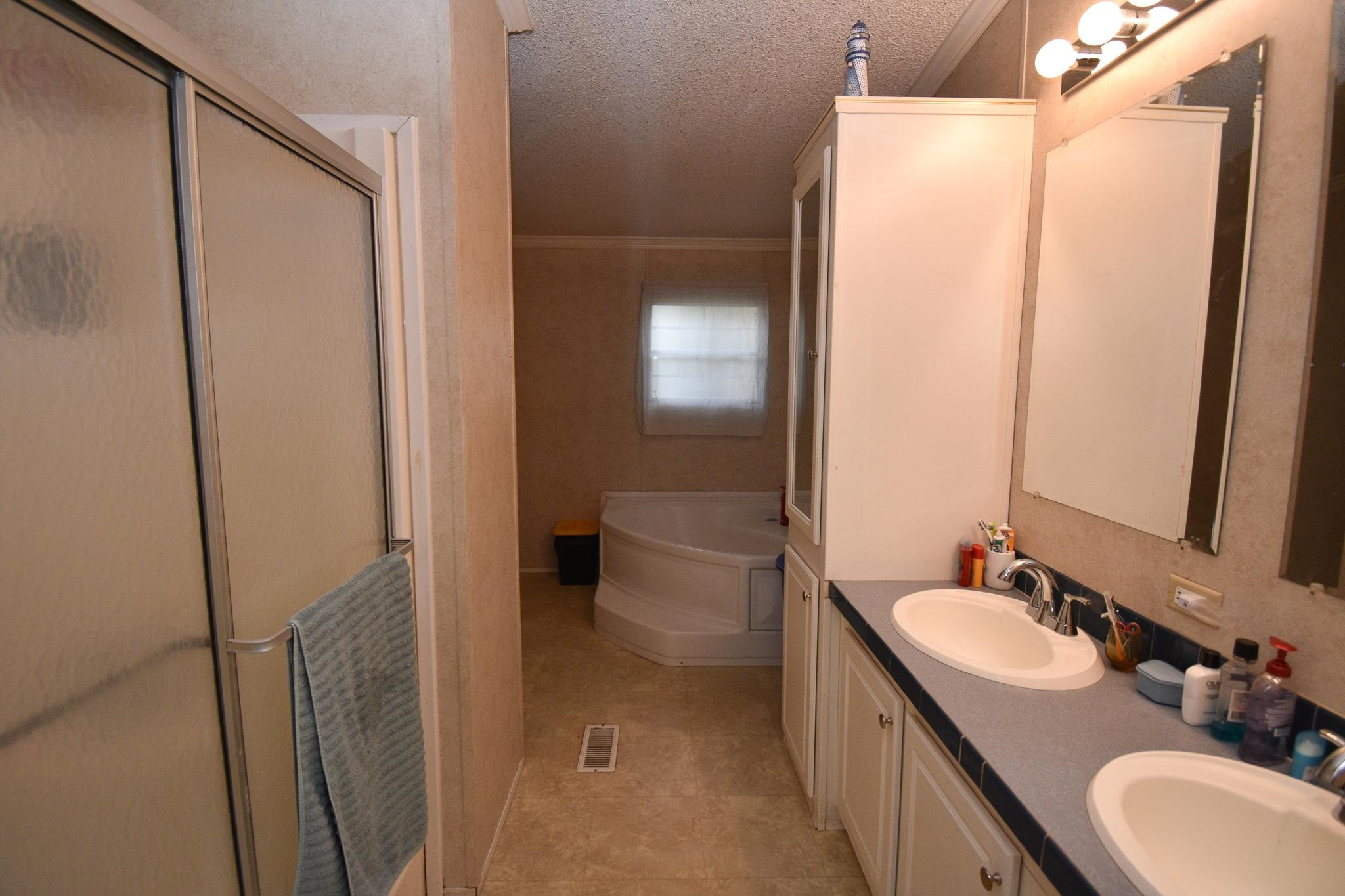 8484 Creek Road Willow Spring, NC 27592 - Photo 24 of 33 a bathroom with a double vanity sink toilet and shower