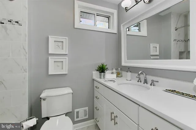 a bathroom with a toilet sink and mirror