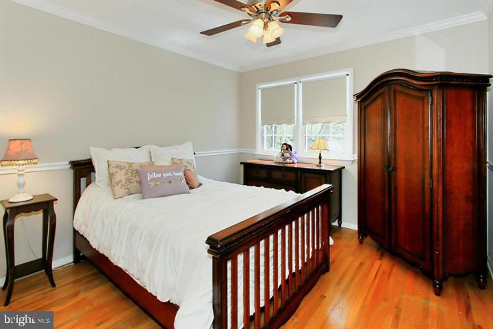 7012 Hadlow Drive Springfield, VA 22152 - Photo 16 of 21 a bedroom with bed and wooden floor