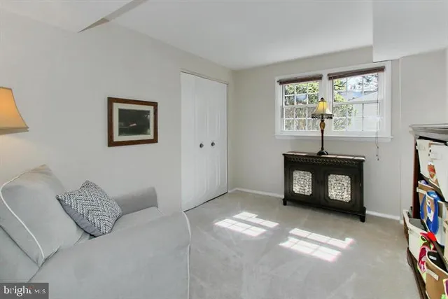 a living room with furniture a window and a flat screen tv