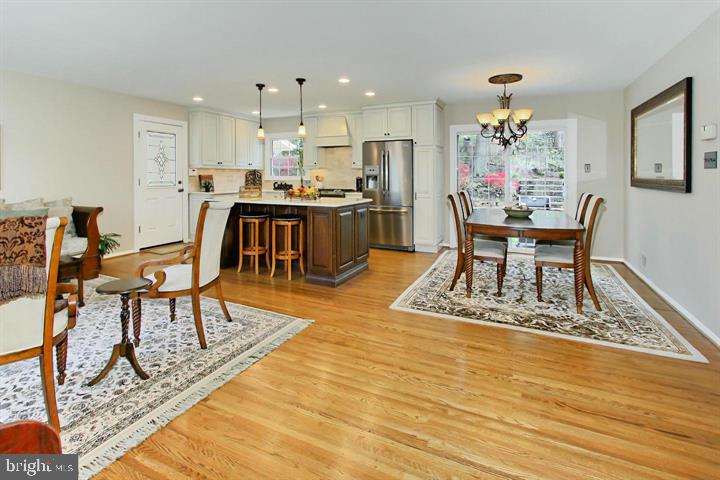 7012 Hadlow Drive Springfield, VA 22152 - Photo 7 of 21 a view of a dining room with furniture and wooden floor