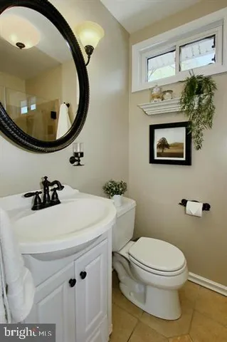 a bathroom with a sink a mirror and toilet