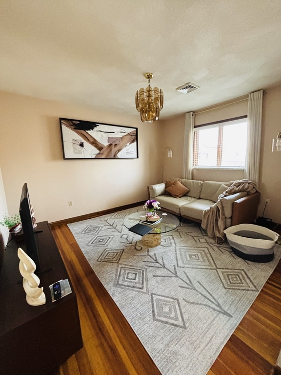24 Meacham Street, Unit 2 Somerville, MA 02145 - Photo 2 of 11 a living room with furniture and a chandelier