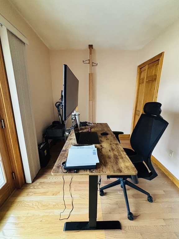 24 Meacham Street, Unit 2 Somerville, MA 02145 - Photo 5 of 11 a room with furniture and wooden floor