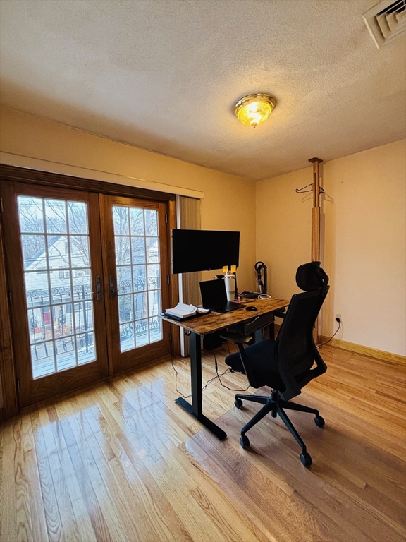 24 Meacham Street, Unit 2 Somerville, MA 02145 - Photo 6 of 11 a view of a workspace with furniture and a window