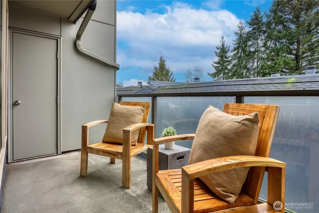 a blue chair sitting in a roof with glass top table and chair