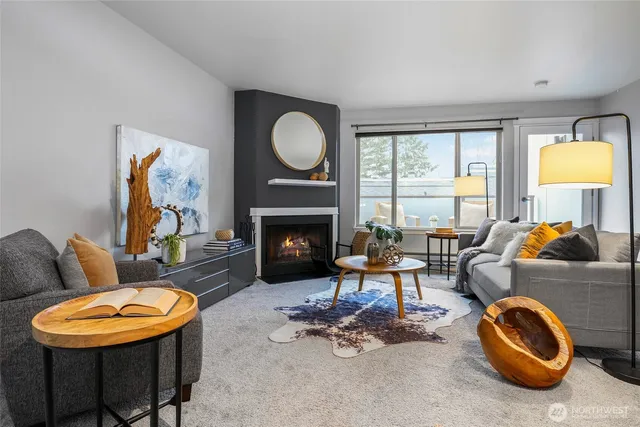 a living room with furniture a window and a fireplace