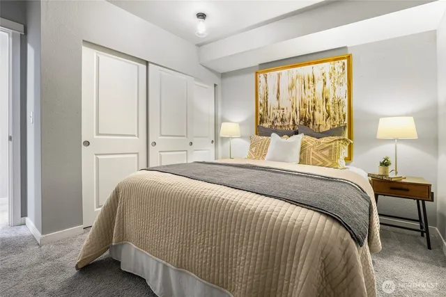 a bedroom with a bed and a lamp