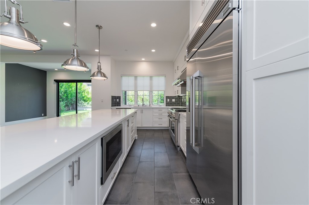 91 Rockinghorse Irvine, CA 92602 - Photo 12 of 48 a open kitchen with a large window and stainless steel appliances