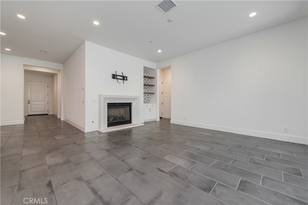 91 Rockinghorse Irvine, CA 92602 - Photo 15 of 48 an empty room with fireplace and mirrors