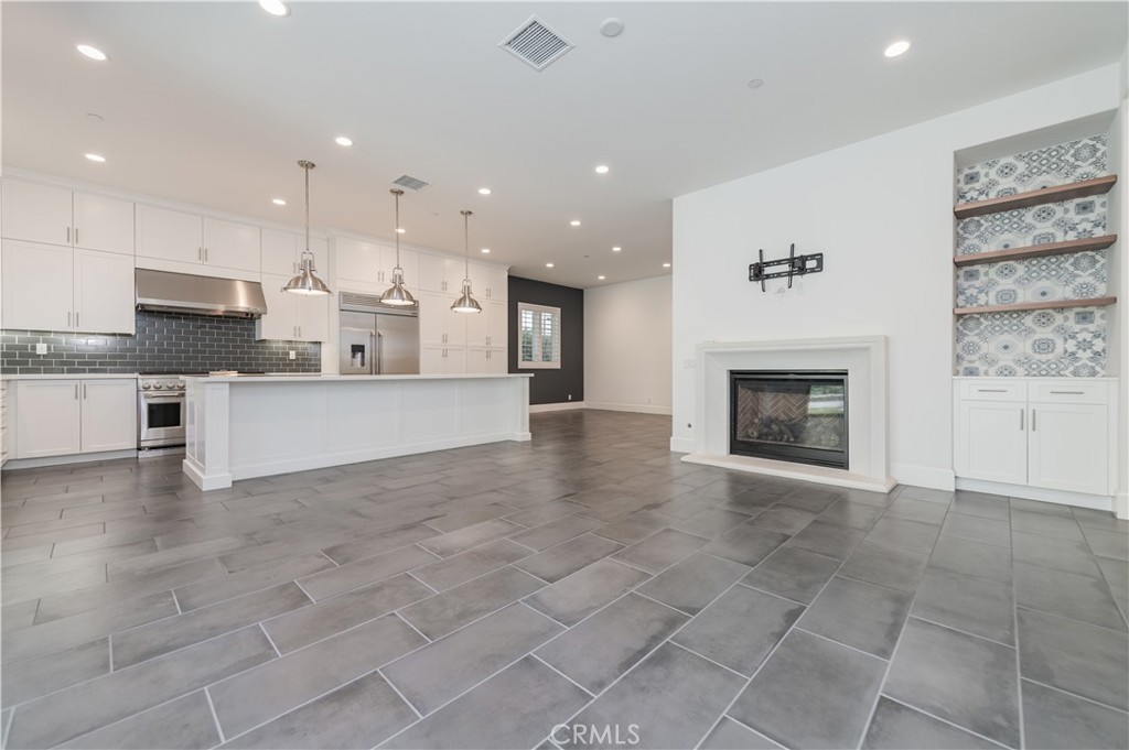 91 Rockinghorse Irvine, CA 92602 - Photo 16 of 48 a view of a kitchen with a sink and a fireplace
