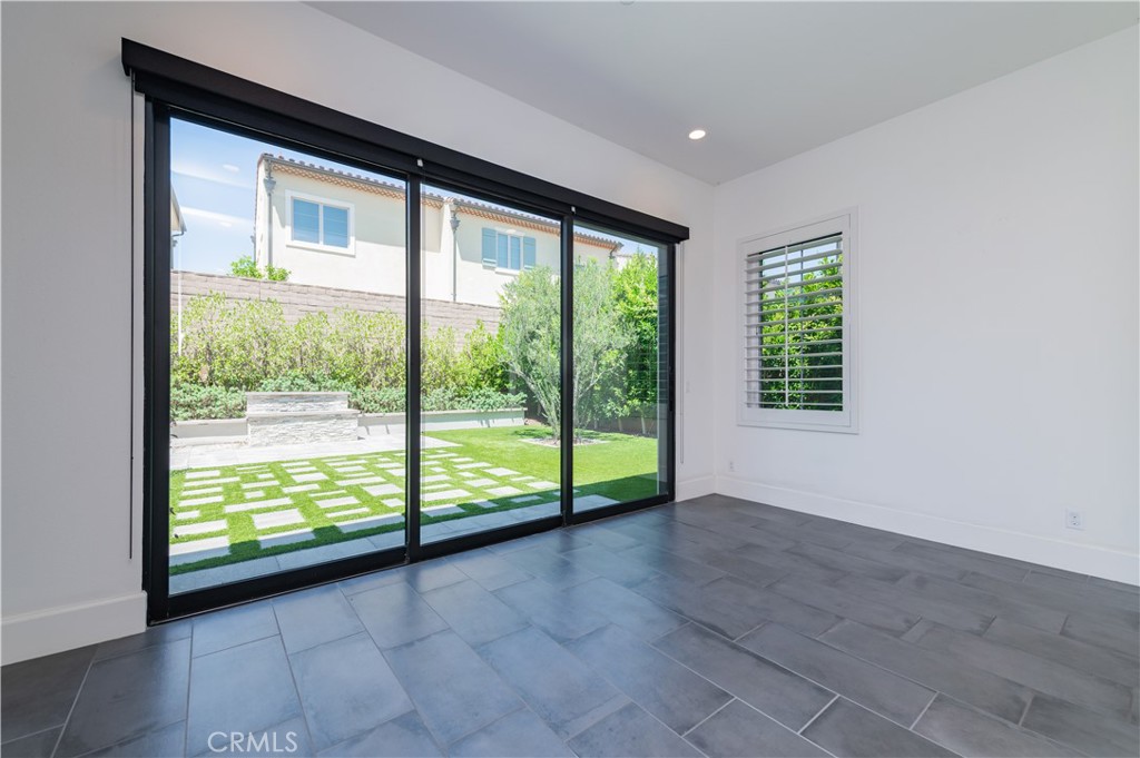 91 Rockinghorse Irvine, CA 92602 - Photo 17 of 48 a view of an empty room with wooden floor and windows