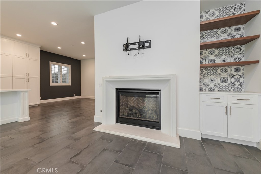 91 Rockinghorse Irvine, CA 92602 - Photo 19 of 48 a view of an empty room with a fireplace and a window