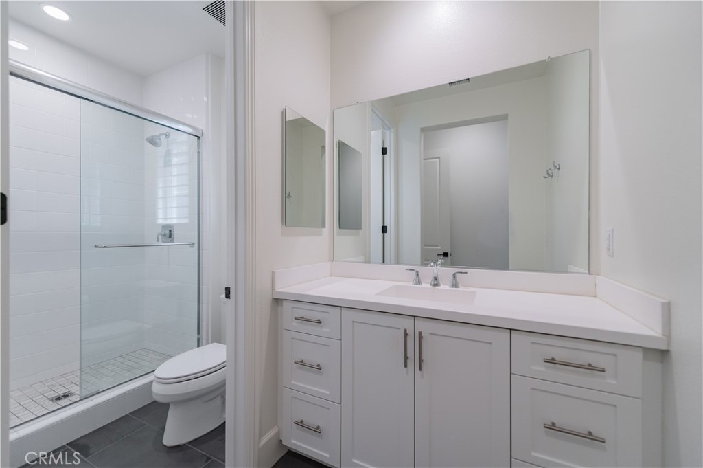 91 Rockinghorse Irvine, CA 92602 - Photo 22 of 48 a bathroom with a double vanity sink toilet and shower