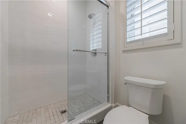 a white toilet next to a window