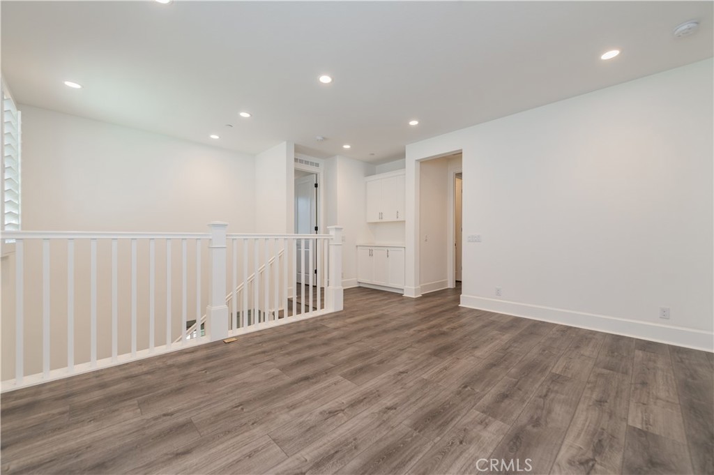 91 Rockinghorse Irvine, CA 92602 - Photo 25 of 48 a view of an empty room with wooden floor