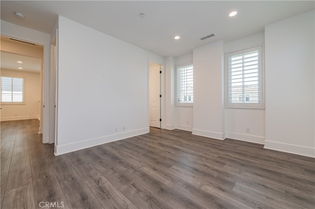 91 Rockinghorse Irvine, CA 92602 - Photo 28 of 48 an empty room with wooden floor and windows