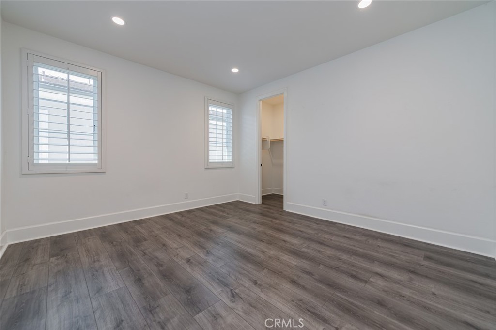 91 Rockinghorse Irvine, CA 92602 - Photo 30 of 48 an empty room with wooden floor and windows
