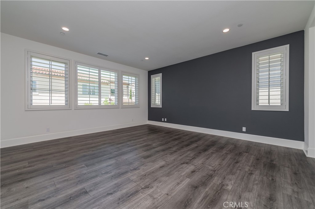 91 Rockinghorse Irvine, CA 92602 - Photo 33 of 48 a view of an empty room with wooden floor and a window