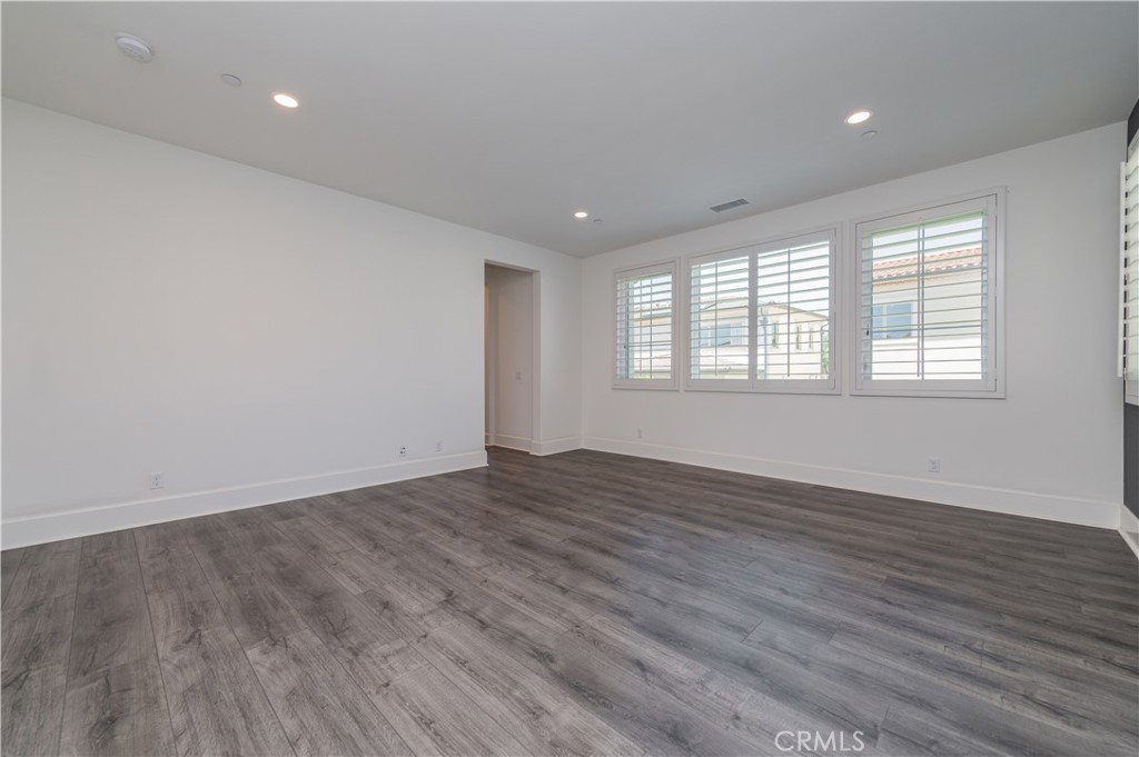 91 Rockinghorse Irvine, CA 92602 - Photo 34 of 48 an empty room with wooden floor and windows
