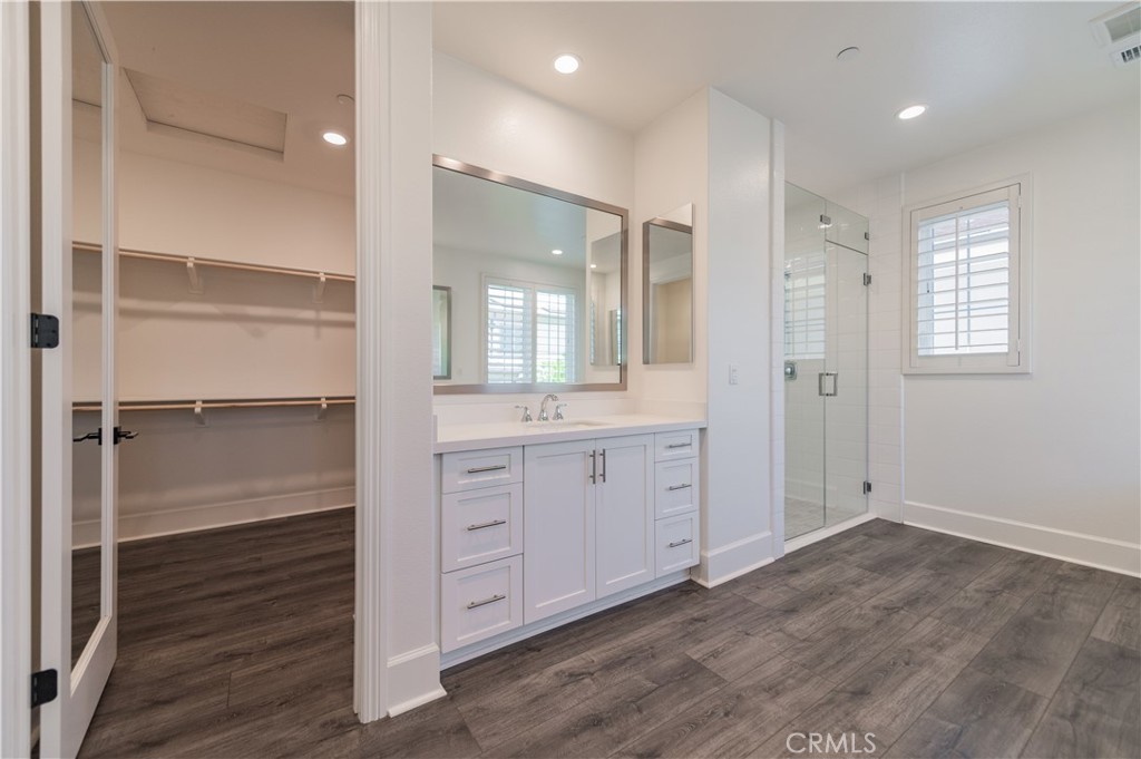91 Rockinghorse Irvine, CA 92602 - Photo 36 of 48 a bathroom with a double vanity sink a mirror and a shower