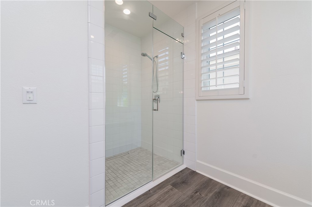 91 Rockinghorse Irvine, CA 92602 - Photo 38 of 48 a bathroom with a glass shower door