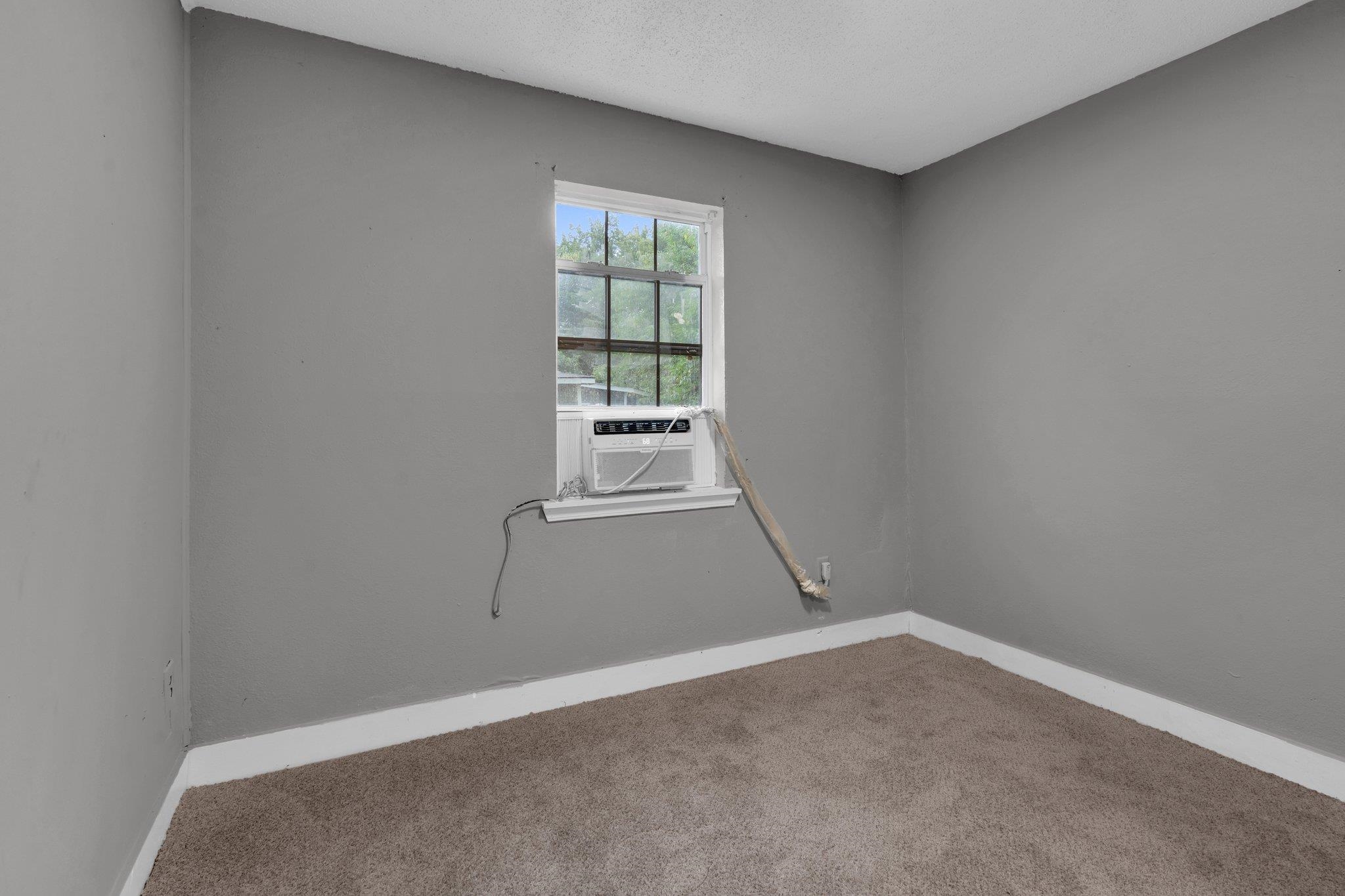 76 Bucksnort Road Covington, TN 38019 - Photo 13 of 21 Carpeted empty room featuring a textured ceiling