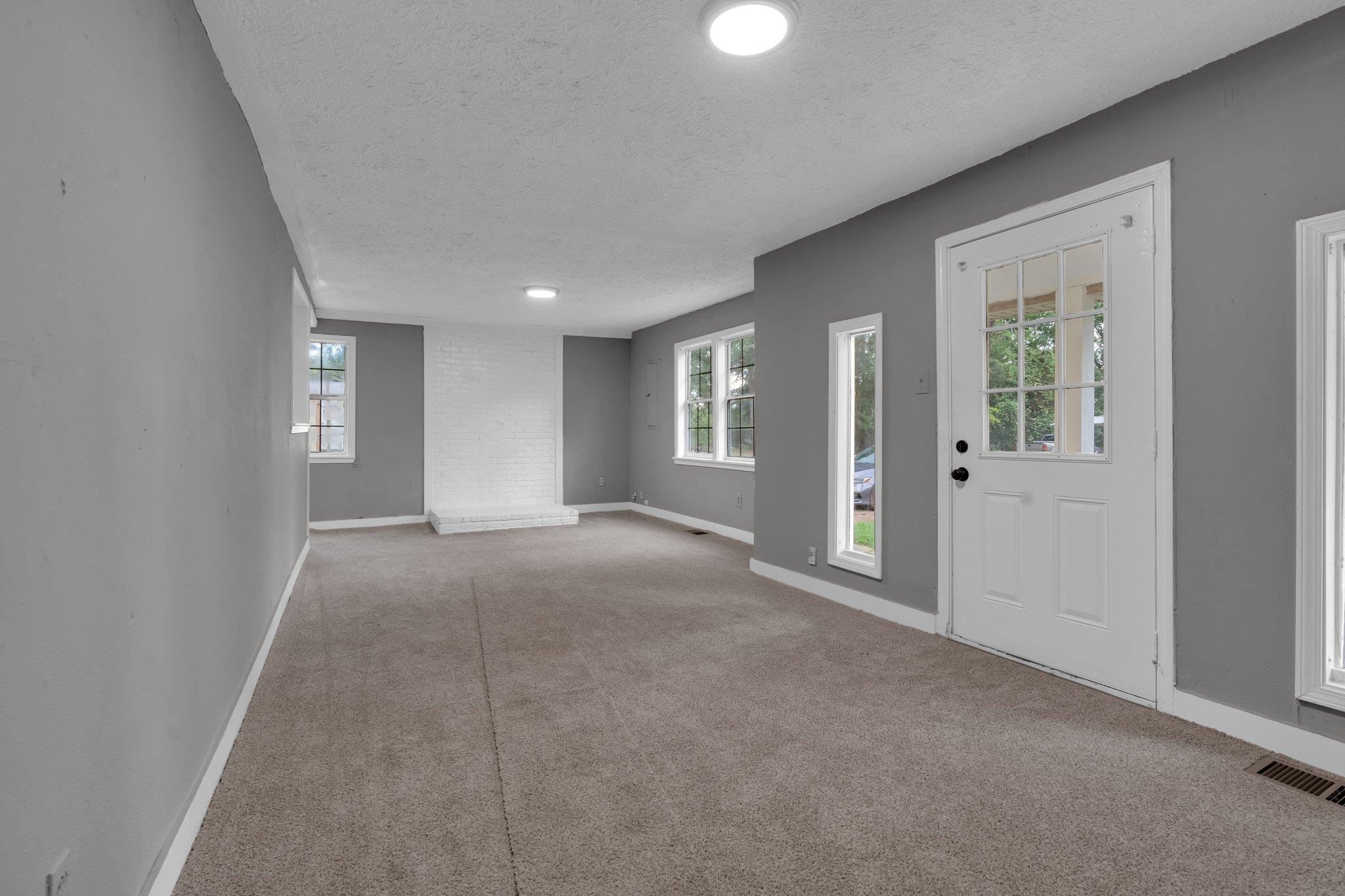 76 Bucksnort Road Covington, TN 38019 - Photo 3 of 21 Living Room with a textured ceiling and light carpet