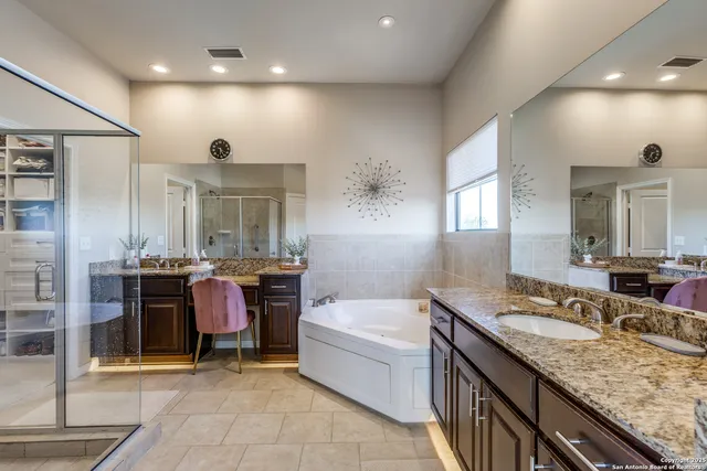 a bathroom with a granite countertop sink a toilet and bathtub